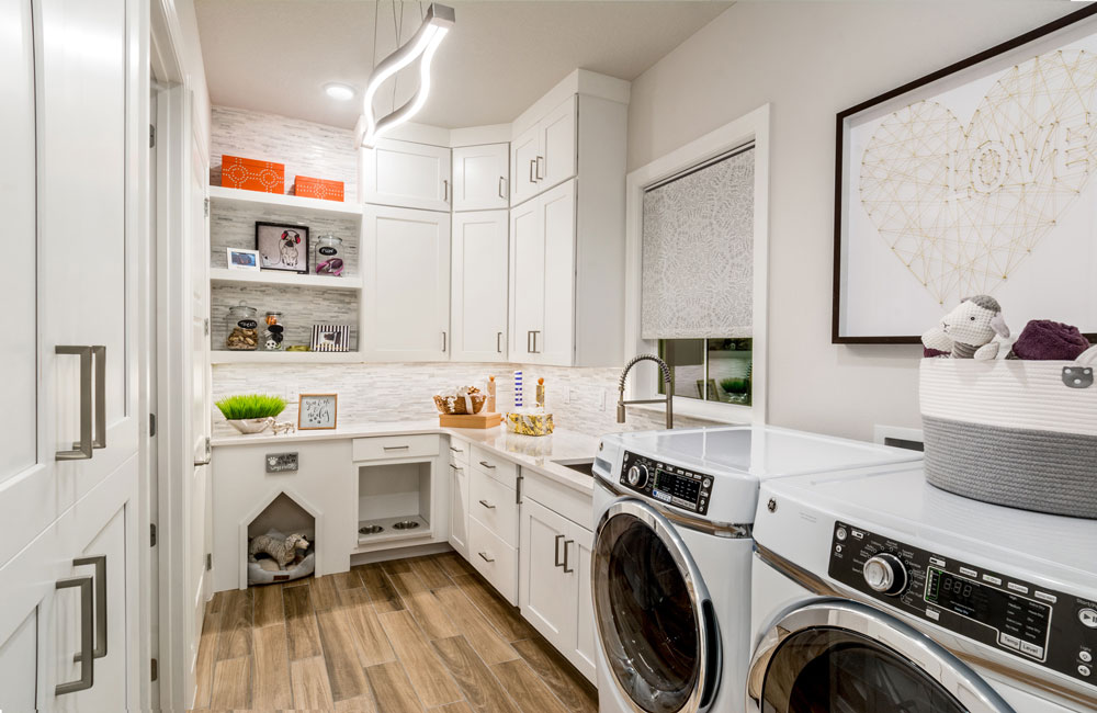 Award winning 55+ model home laundry room with pet storage and built in water bowl in Florida.
