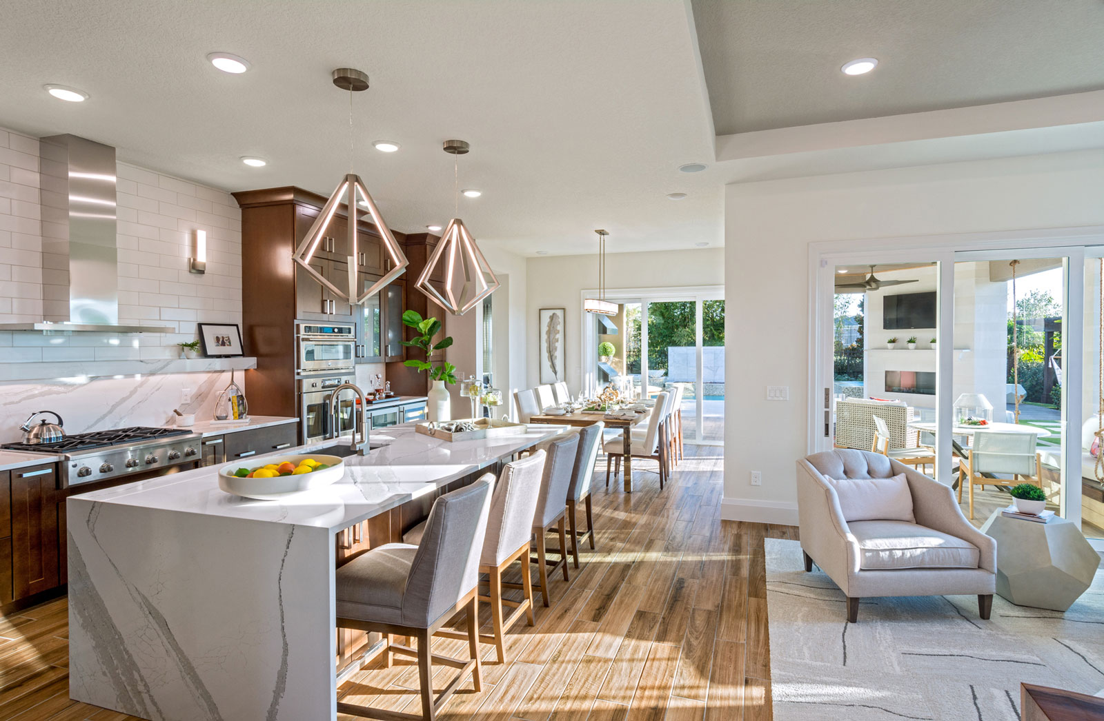 Award winning 55+ model home kitchen with and open floorplan, unique white backsplash, and hardwood floors in Florida.