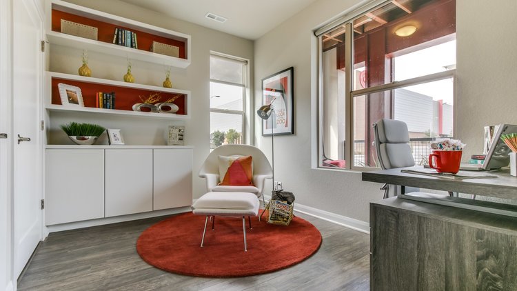 Interior design maximizing small space with white walls and red accents