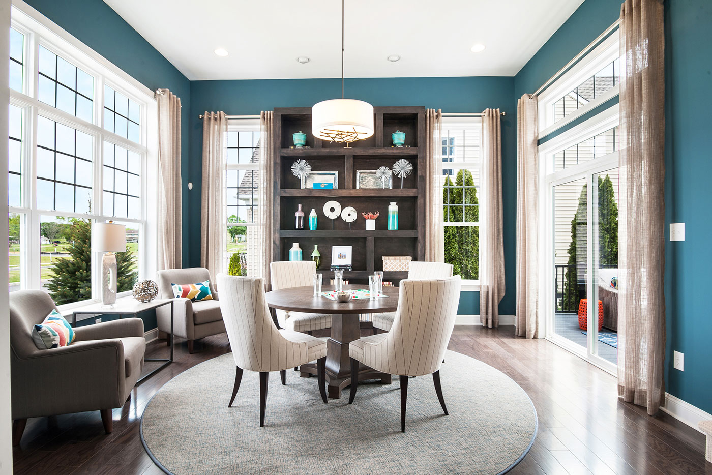 Model home flex space with dramatic turquoise accent walls and dark wood built ins, in Glassboro, New Jersey.