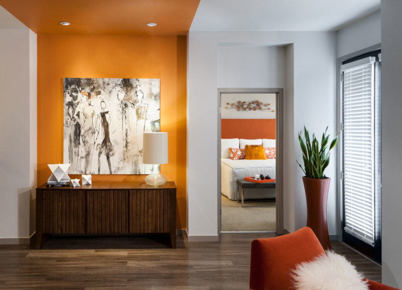 Luxury apartment merchandised with high-end finishes orange accents, and contemporary art in Englewood, Colorado.