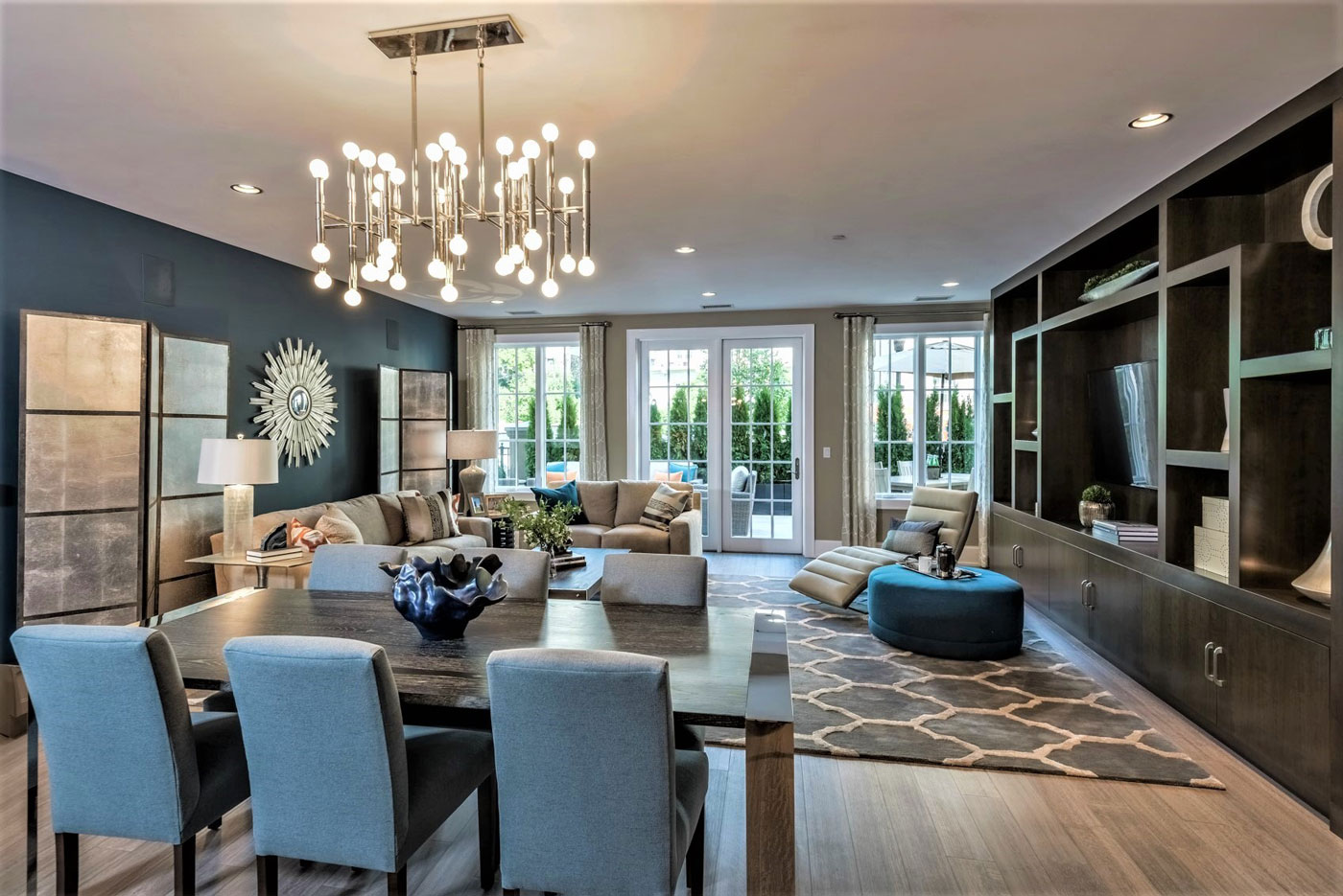 Chic dining and living room area with elegantly merchandised dark wood built-ins and an open floor plan in New York.