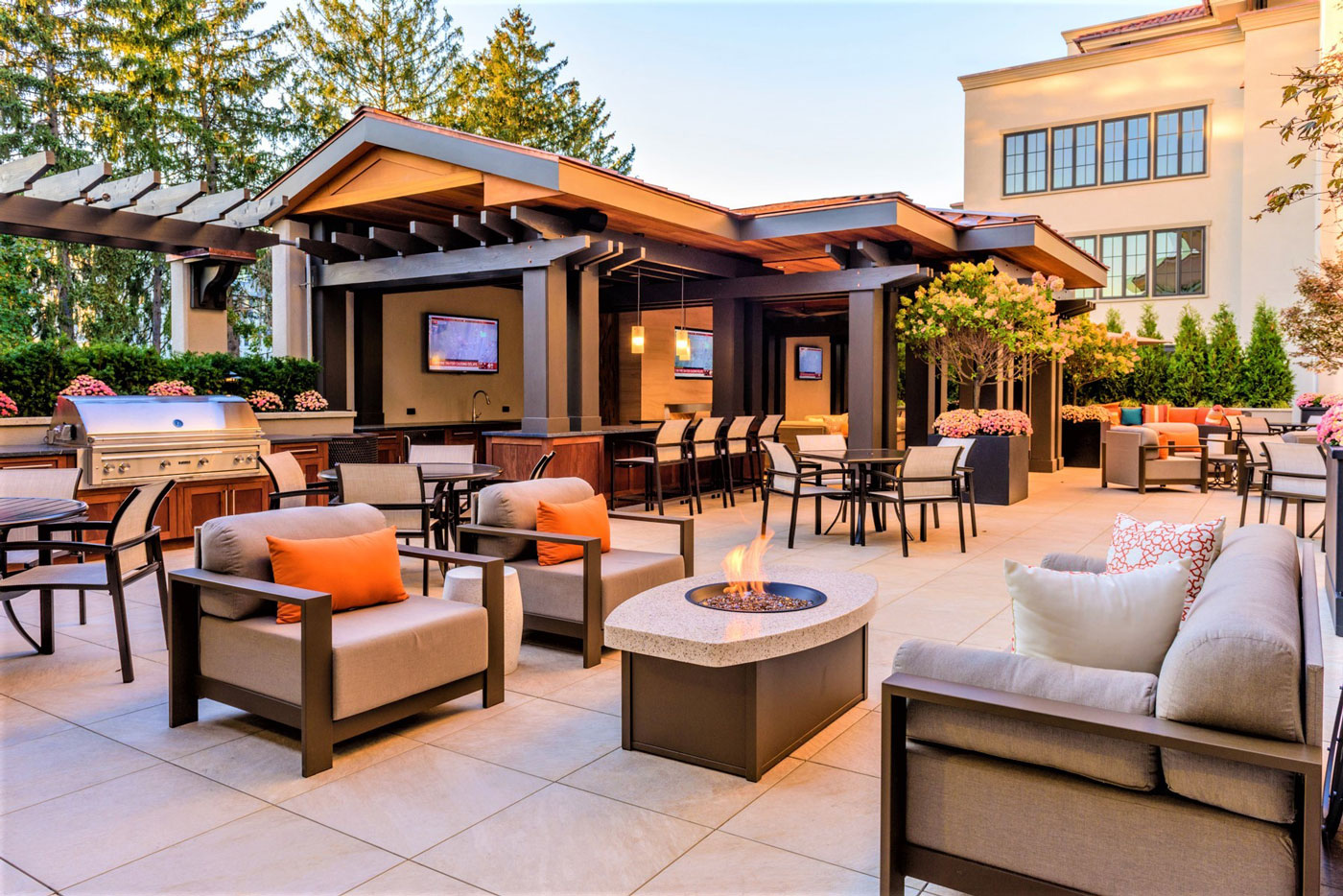 Large outdoor amenity area with bar, grill, fire pit, with variety of welcoming seating options in New York.