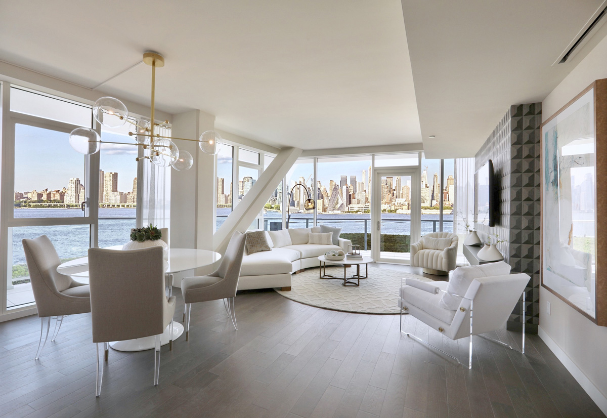Upscale condo with breathtaking view of NYC skyline elegantly merchandised with white modern design in New Jersey.