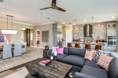 Model home with open floor plan, modern kitchen and merchandised with a contemporary bohemian flare in Florida.