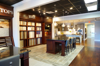 Design center with stunning dark wood floors and finishes showcasing tile and countertop options in North Carolina.