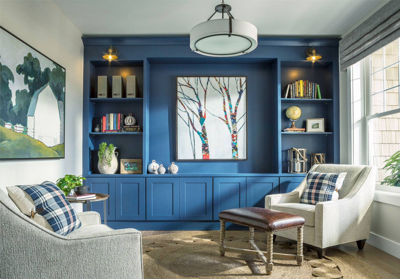 Blue accent wall with built-ins merchandised with comfortable chairs and complimenting finishes for cozy space in Vermont.