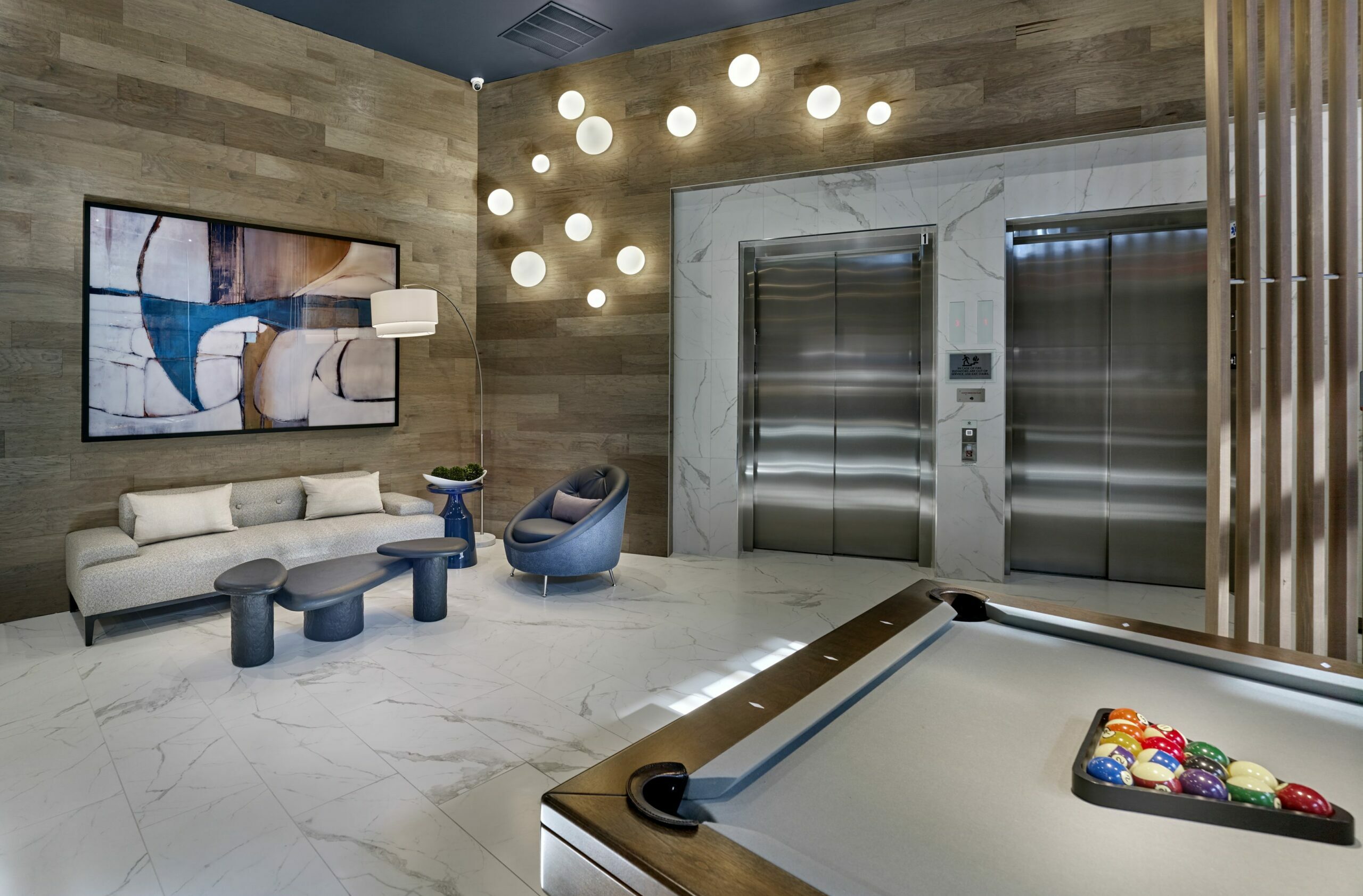 Lounge and game room in luxury multifamily amenity space in New Jersey.